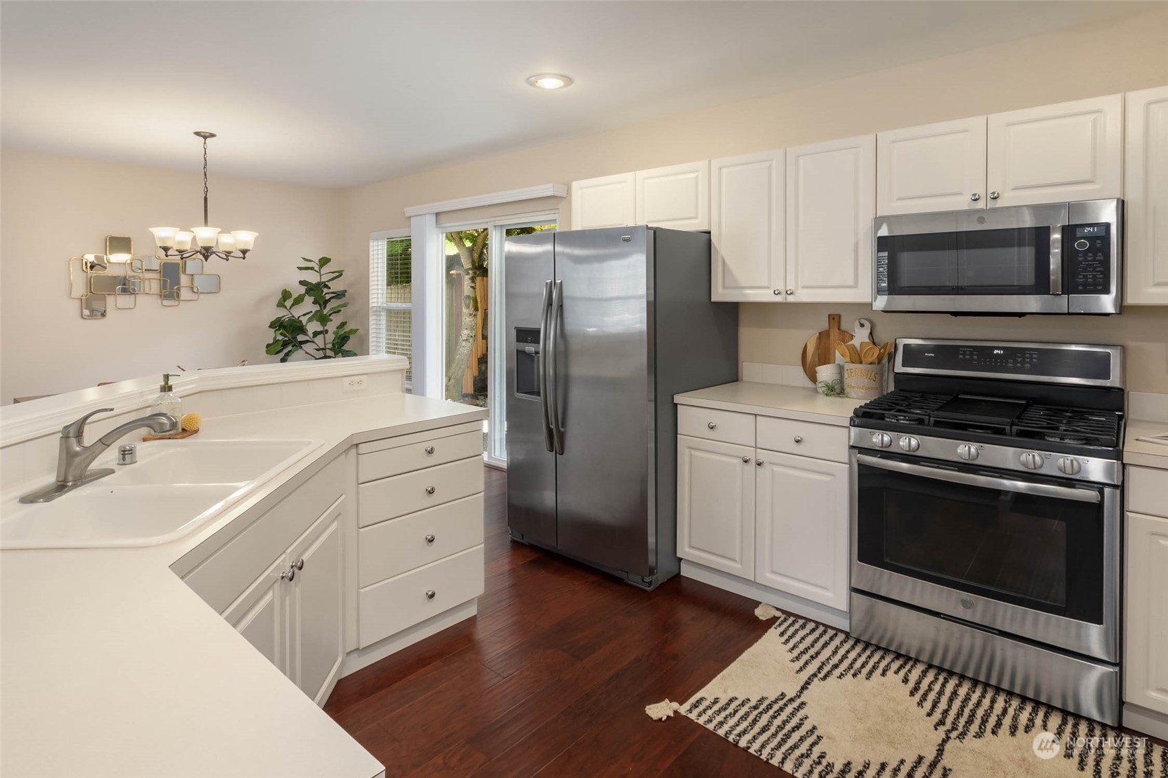 3910 Northeast 5th Place Renton, WA 98056 - Photo 11 of 27 a kitchen with stainless steel appliances a stove a sink and a refrigerator
