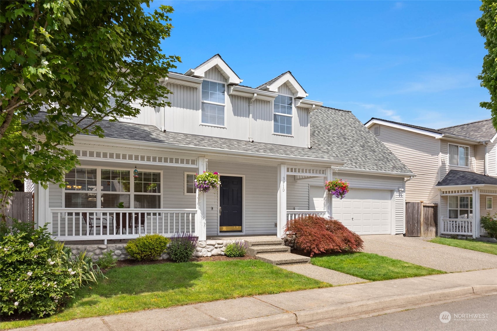 3910 Northeast 5th Place Renton, WA 98056 - Photo 2 of 27 a front view of a house with a garden and plants