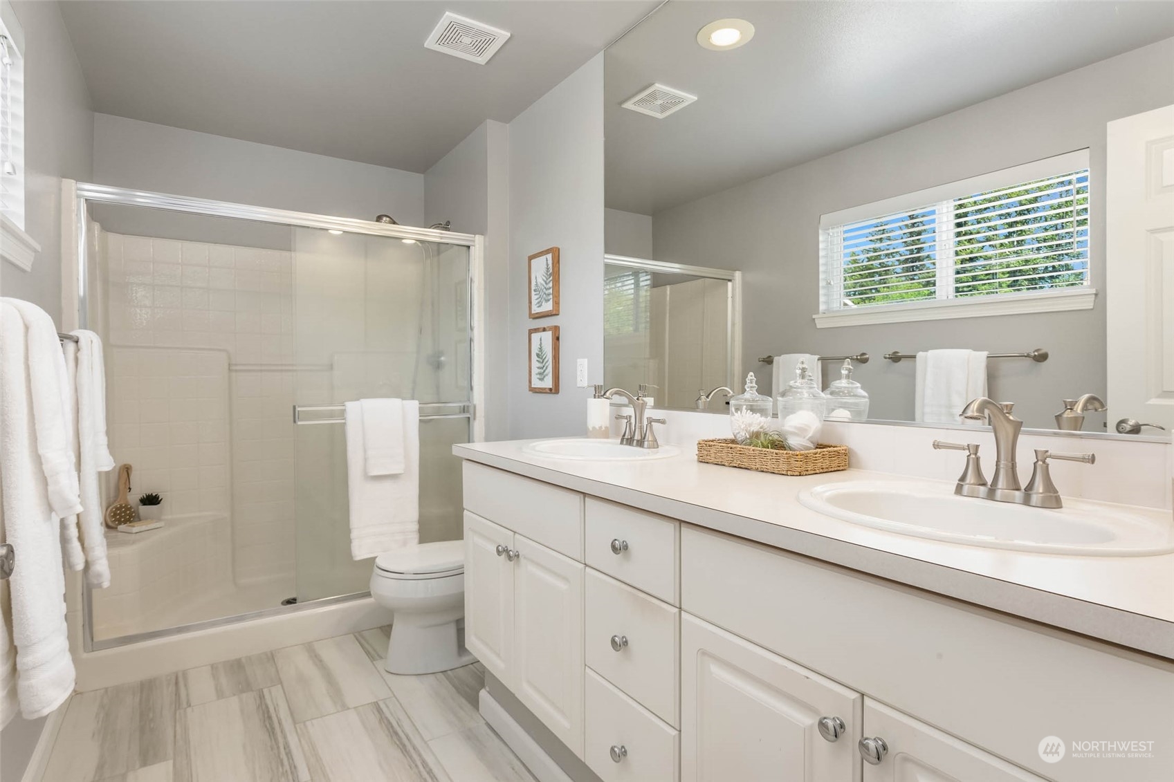 3910 Northeast 5th Place Renton, WA 98056 - Photo 23 of 27 a bathroom with a double vanity sink toilet and shower