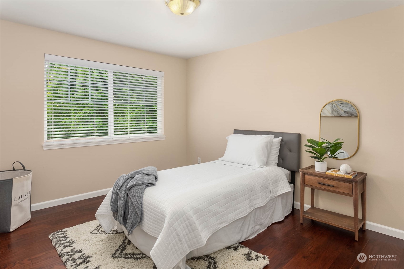 3910 Northeast 5th Place Renton, WA 98056 - Photo 24 of 27 a bedroom with a bed and wooden floor