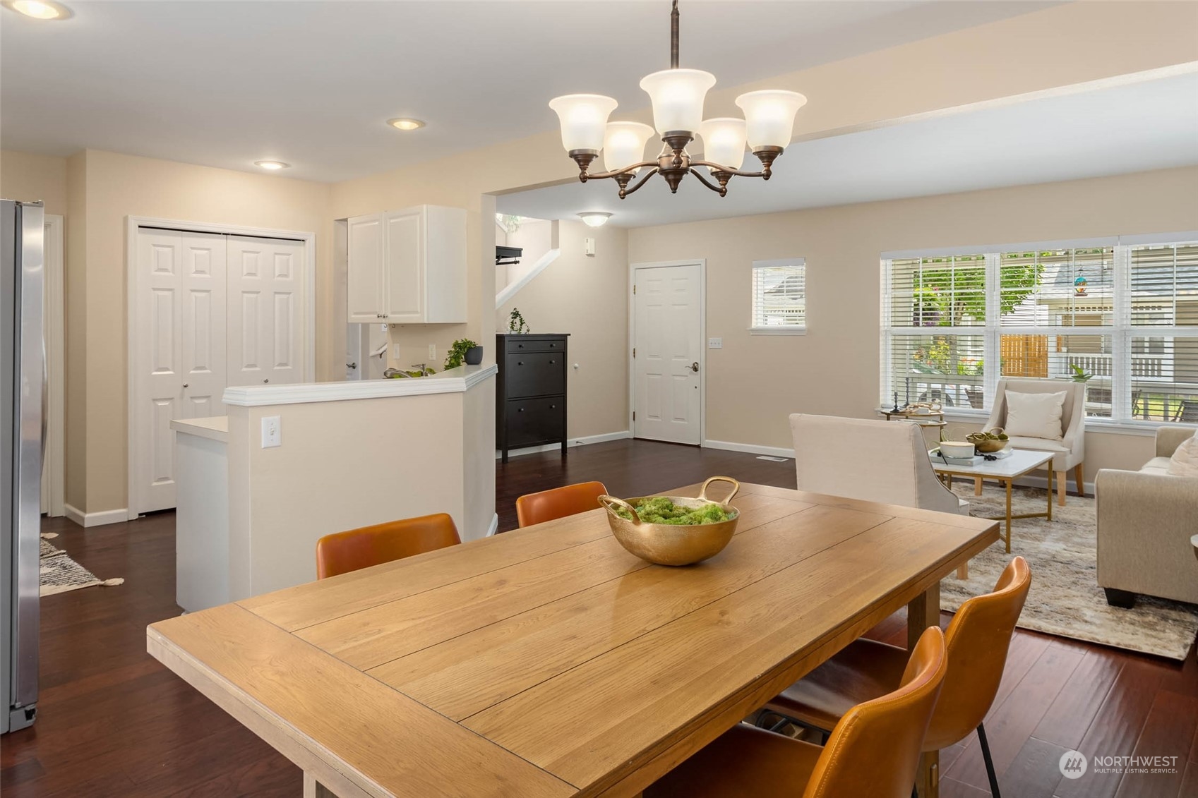 3910 Northeast 5th Place Renton, WA 98056 - Photo 8 of 27 a view of a dining room with furniture a chandelier and wooden floor