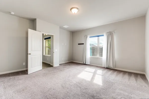 a bathroom with a bathtub double vanity sink and a large mirror