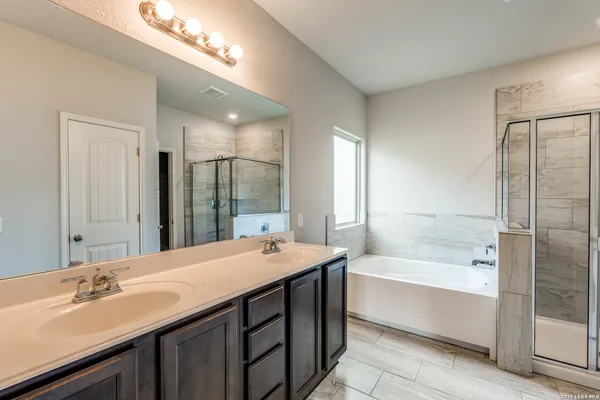 a bathroom with a bathtub and shower
