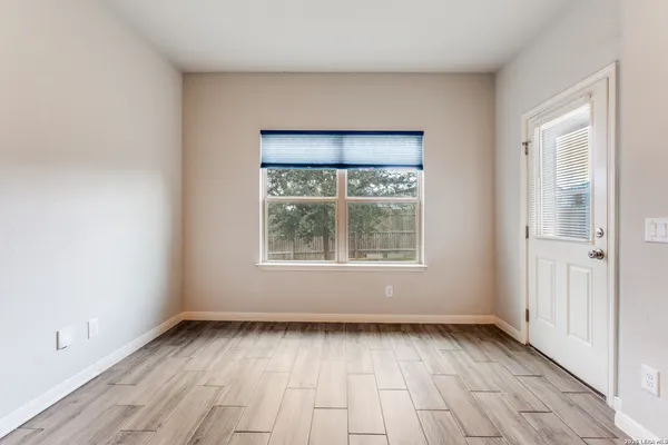 a view of a house with a yard and potted plants