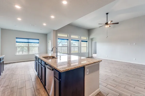 an open kitchen with a sink and dish washer
