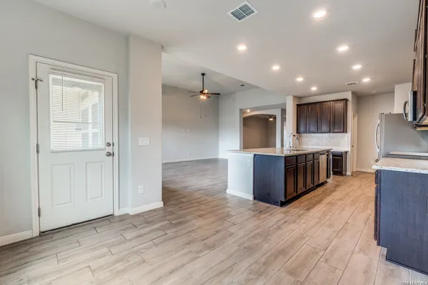 a kitchen with stainless steel appliances granite countertop a stove a sink and a microwave