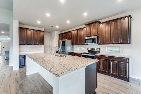 a spacious bedroom with a bed and a dresser