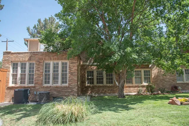 a dining room with furniture a chandelier and wooden floor