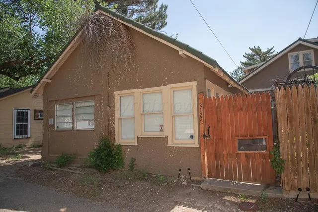 a kitchen with stainless steel appliances granite countertop a stove a refrigerator and a dining table with wooden floor