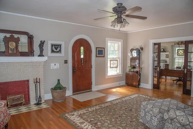 a view of a hallway with wooden floor and a chandelier