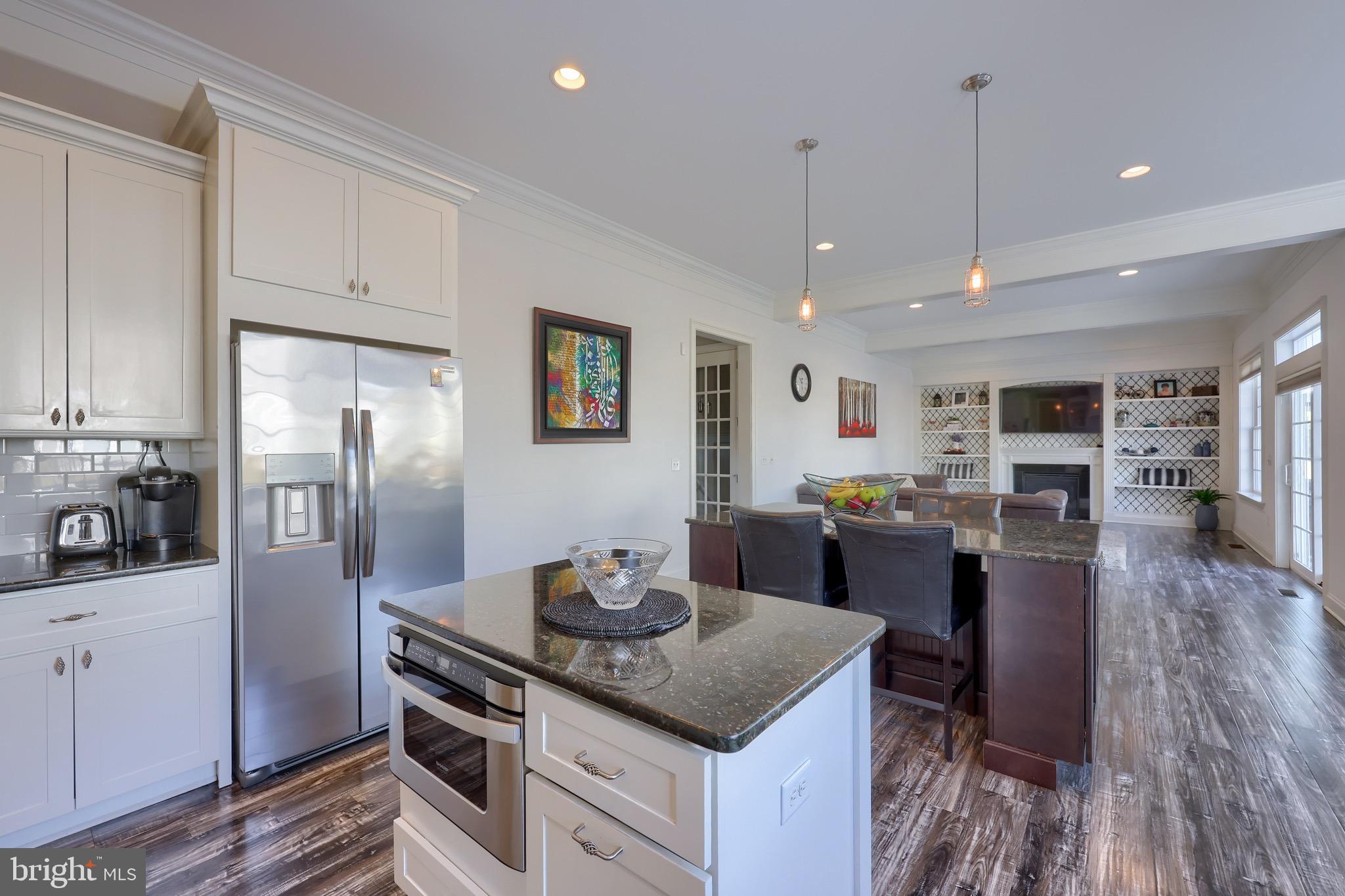 698 Warminster Lane Lititz, PA 17543 - Photo 8 of 49 a kitchen with stainless steel appliances granite countertop a refrigerator a stove top oven a sink dishwasher and white cabinets with wooden floor