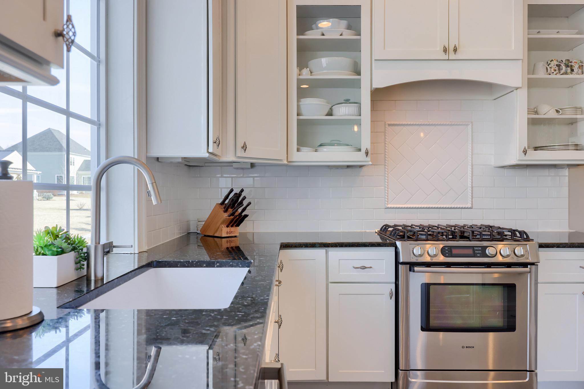 698 Warminster Lane Lititz, PA 17543 - Photo 10 of 49 a kitchen with stainless steel appliances granite countertop a stove a sink and a white cabinets