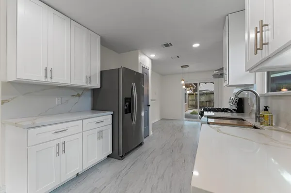 a kitchen with stainless steel appliances a refrigerator sink and cabinets