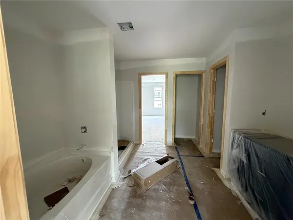 a spacious bedroom with a bed and a couch