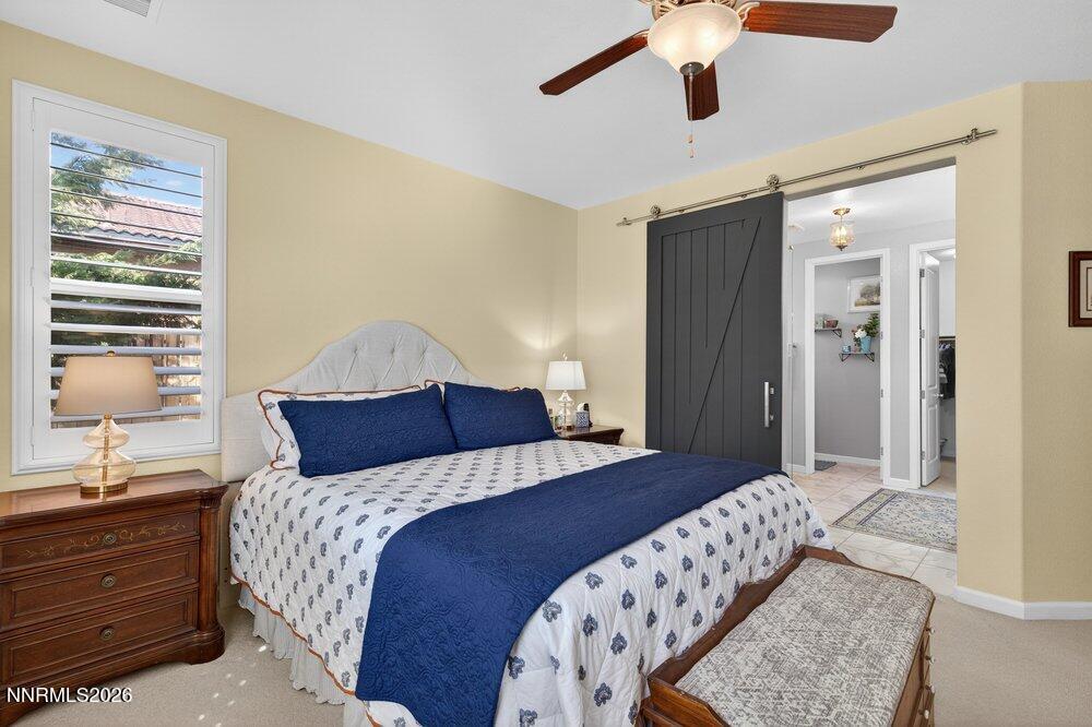 1473 Hogadon Way Reno, NV 89523 - Photo 17 of 40 a bedroom with a bed and a chandelier