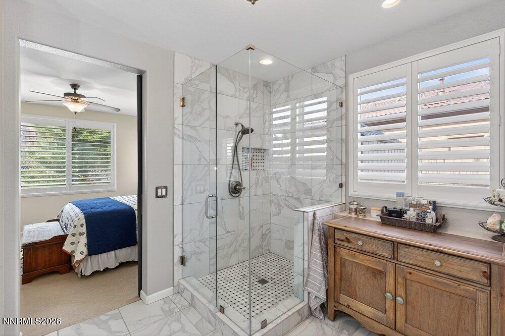 1473 Hogadon Way Reno, NV 89523 - Photo 19 of 40 a bathroom with a granite countertop tub shower and a sink
