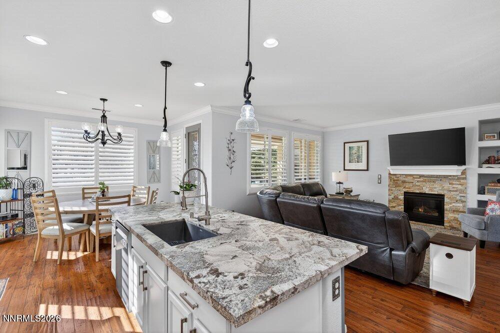 1473 Hogadon Way Reno, NV 89523 - Photo 9 of 40 a kitchen with stainless steel appliances granite countertop a sink a stove and a wooden floors