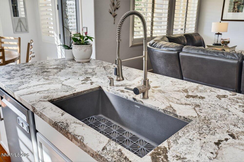 1473 Hogadon Way Reno, NV 89523 - Photo 10 of 40 a kitchen with granite countertop a sink and a stove