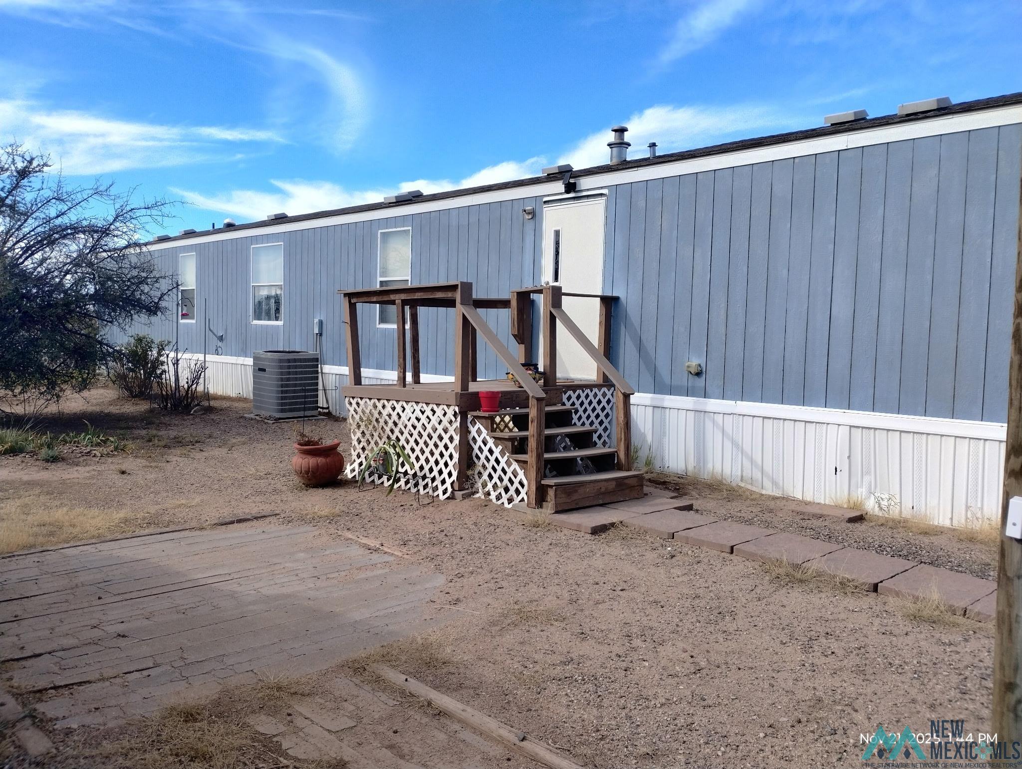 Back of property featuring a deck
