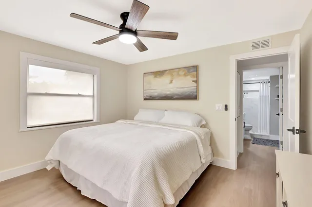 a bedroom with a large bed and a window