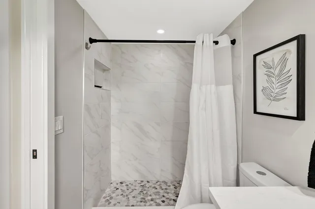 a bathroom with a shower and a curtain