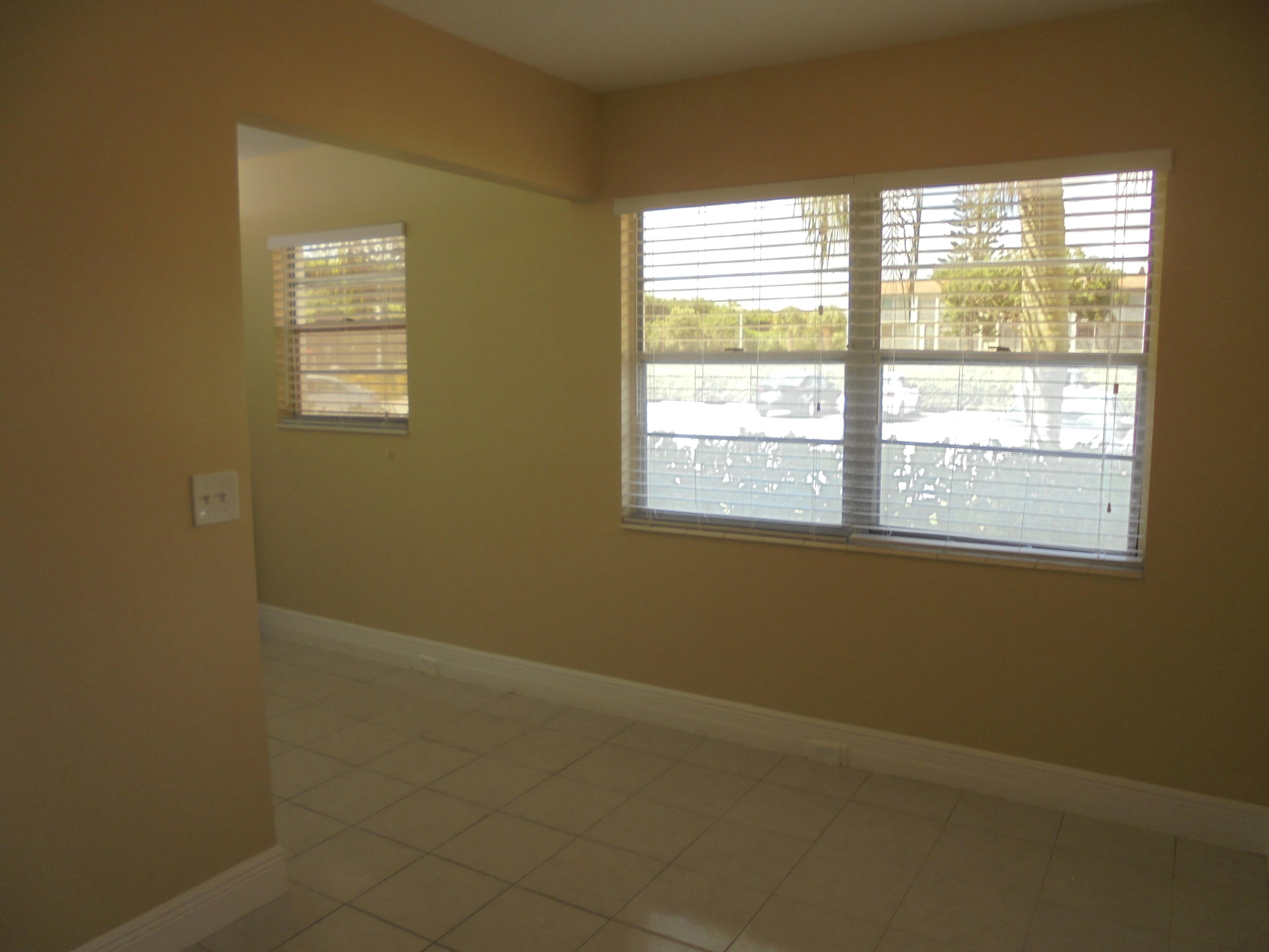 98 Fanshaw C Boca Raton, FL 33434 - Photo 3 of 11 an empty room with a window
