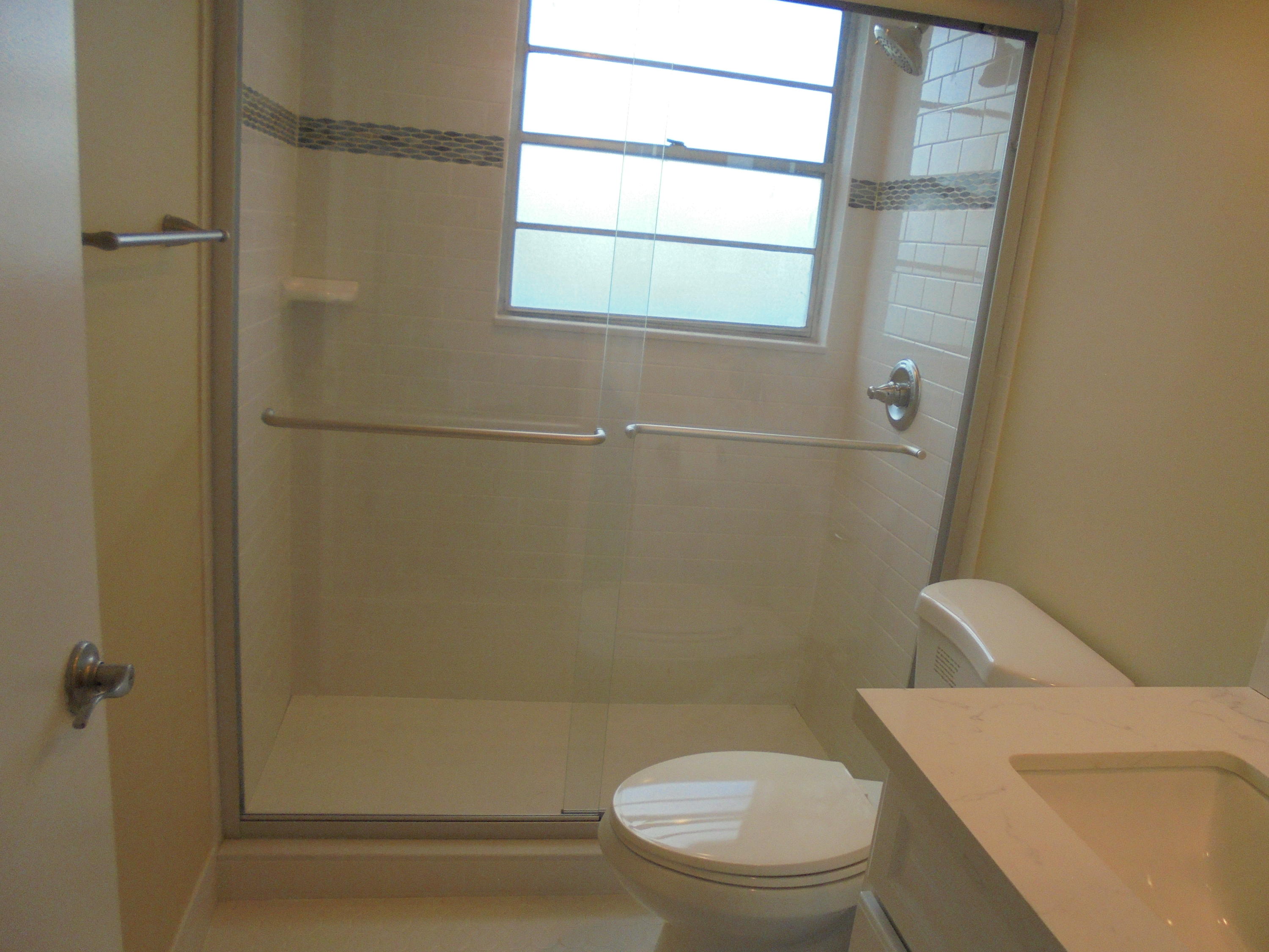 98 Fanshaw C Boca Raton, FL 33434 - Photo 5 of 11 a white toilet sitting next to a shower