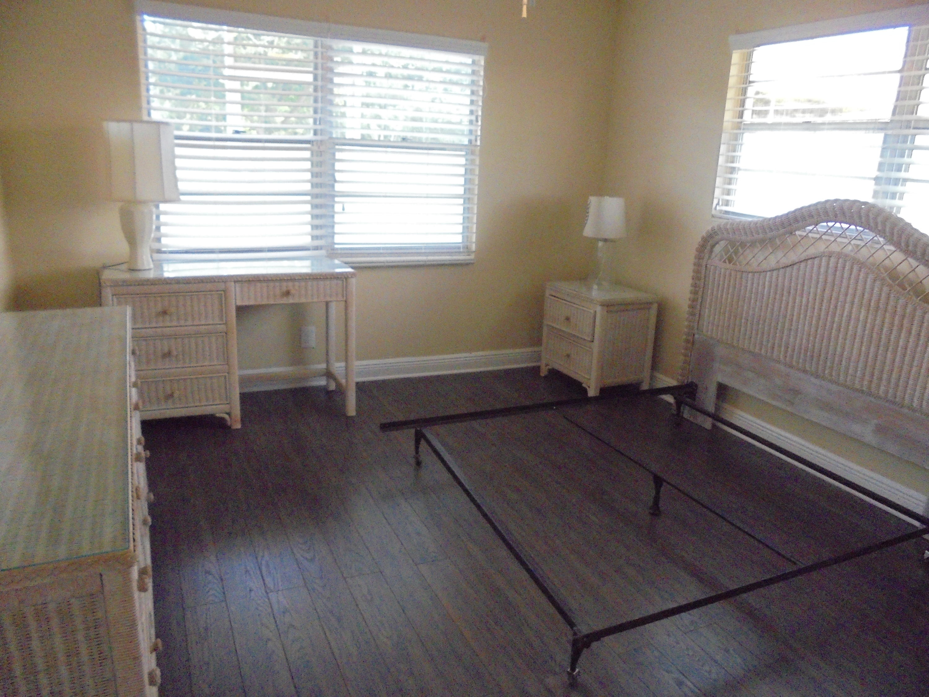 98 Fanshaw C Boca Raton, FL 33434 - Photo 7 of 11 a view of a bedroom with wooden floor and windows
