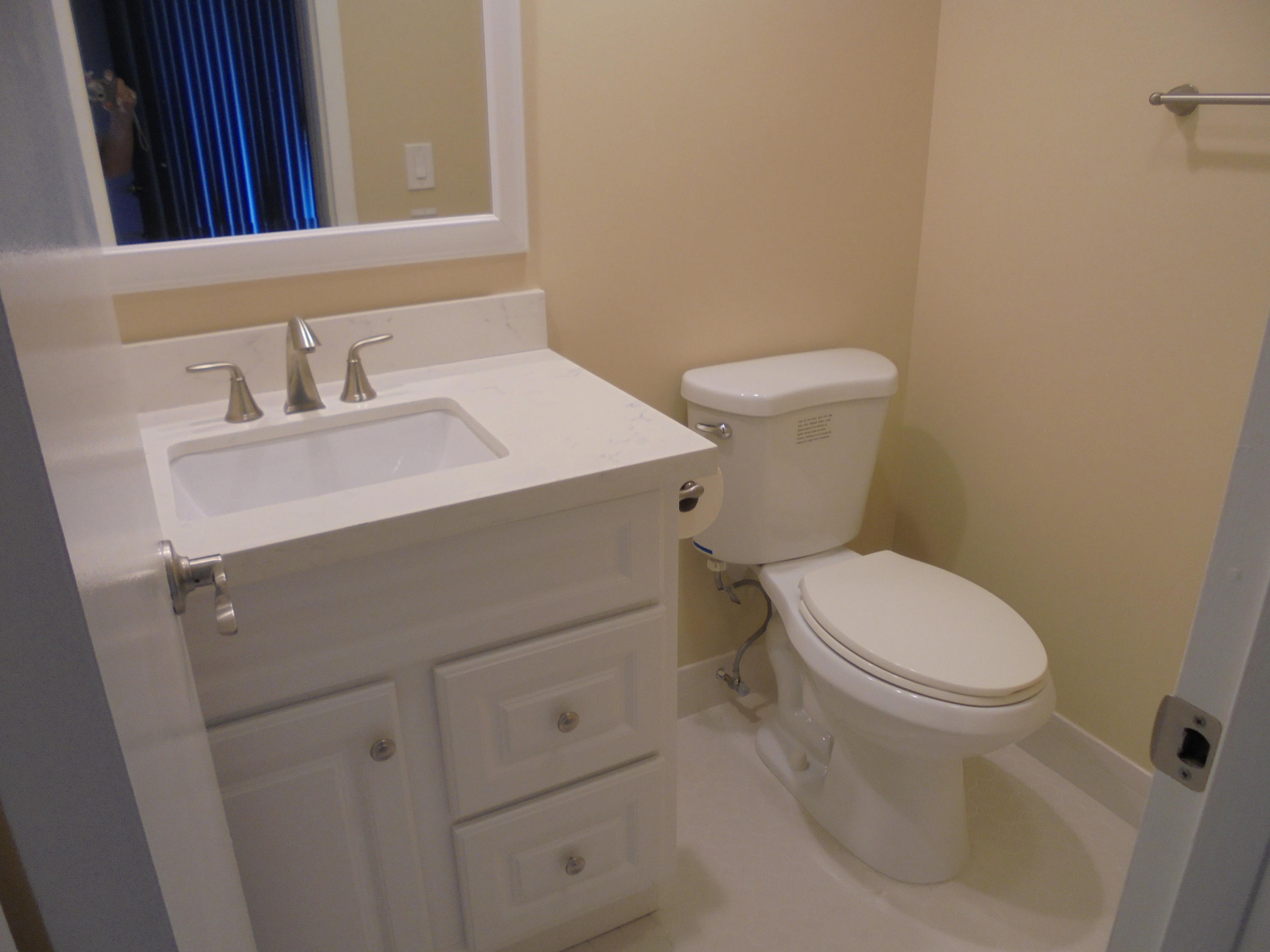 98 Fanshaw C Boca Raton, FL 33434 - Photo 9 of 11 a bathroom with a sink toilet and mirror