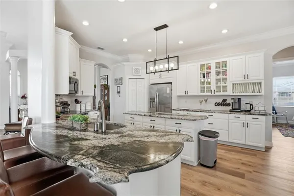 a kitchen with a stove a sink and a refrigerator