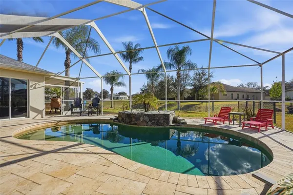 a view of swimming pool with outdoor seating