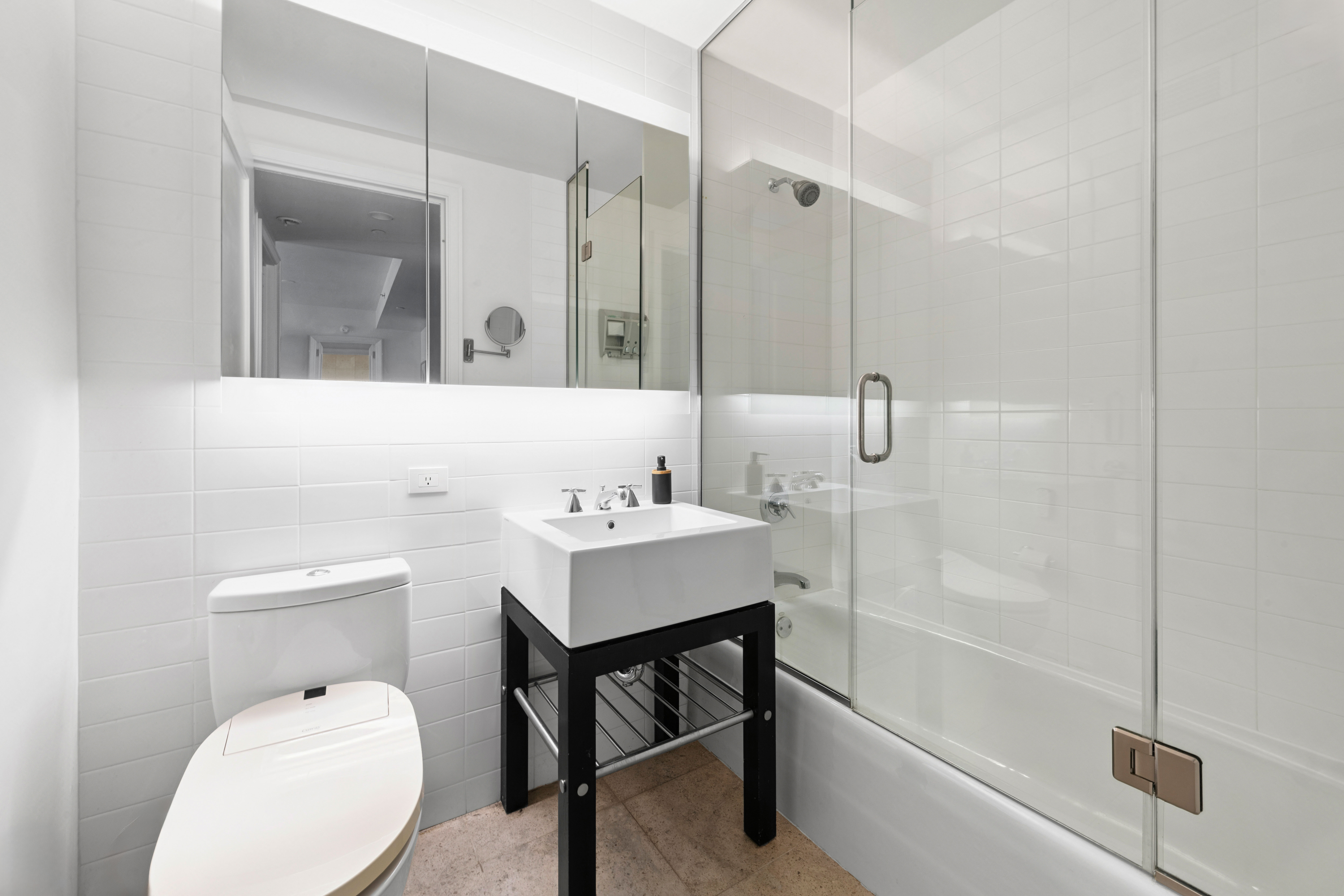 70 Little West Street, Unit 22G Manhattan, NY 10004 - Photo 10 of 13 a bathroom with a sink a toilet and shower