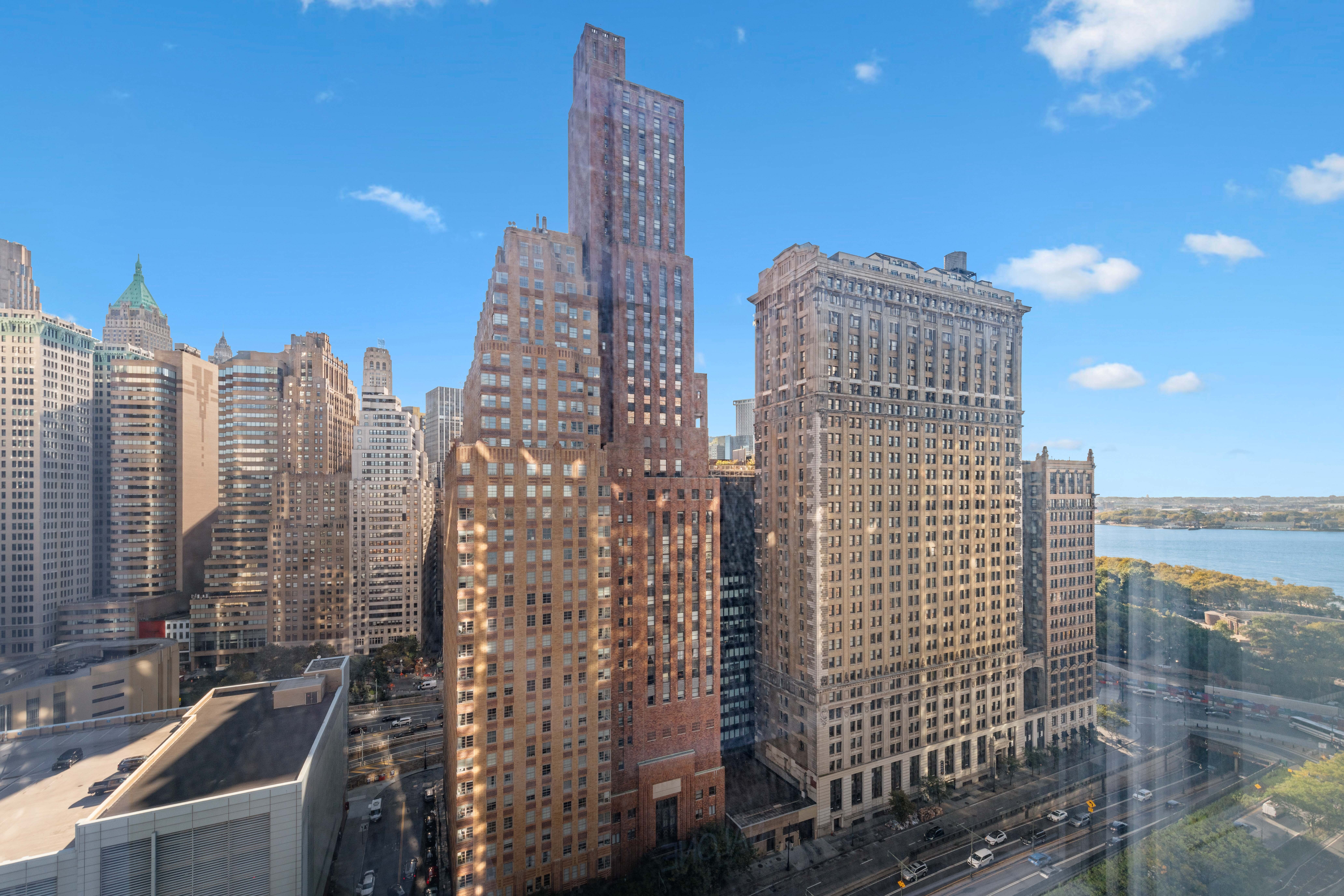 70 Little West Street, Unit 22G Manhattan, NY 10004 - Photo 11 of 13 a view of a city with tall buildings