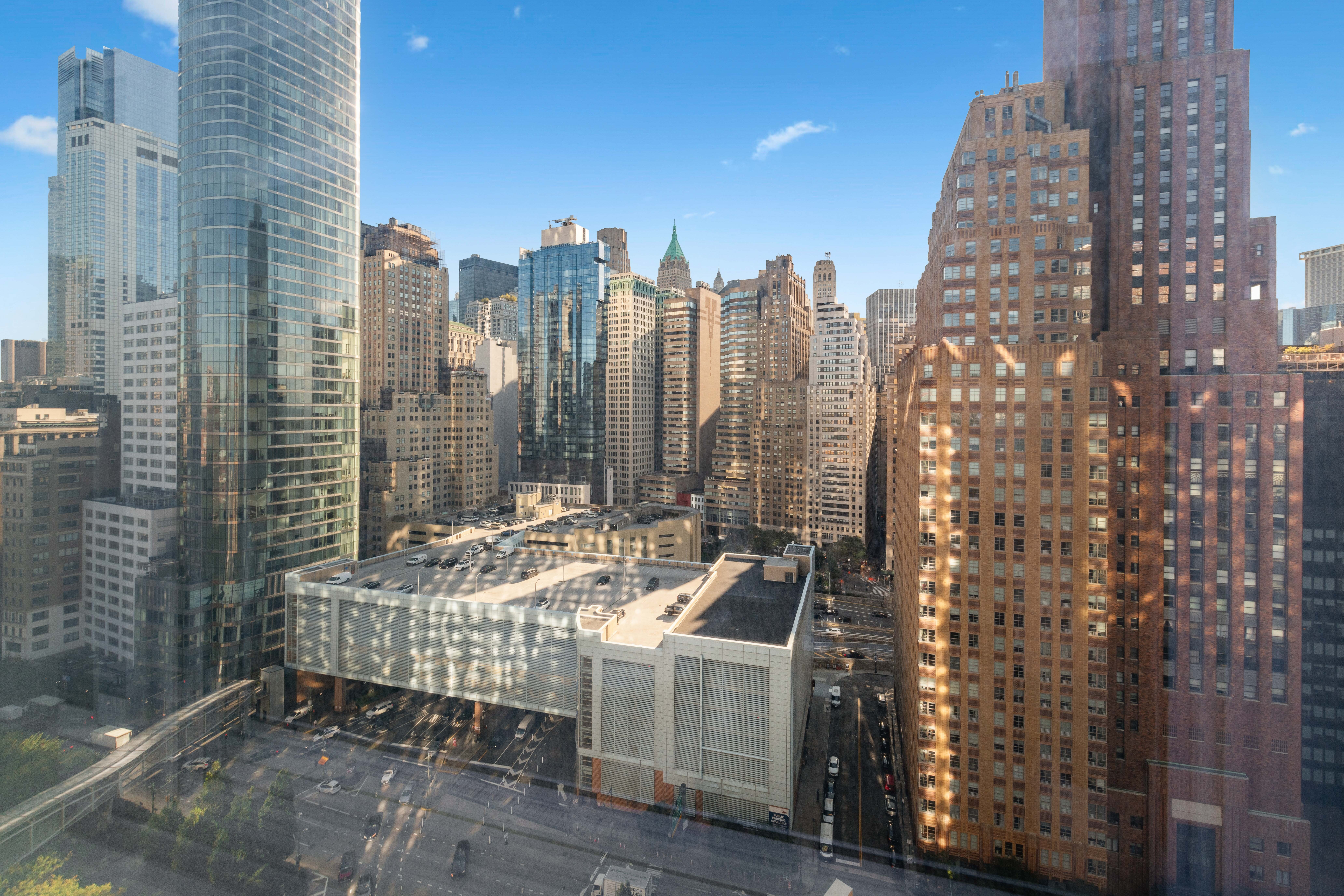 70 Little West Street, Unit 22G Manhattan, NY 10004 - Photo 12 of 13 a roof deck with tall trees