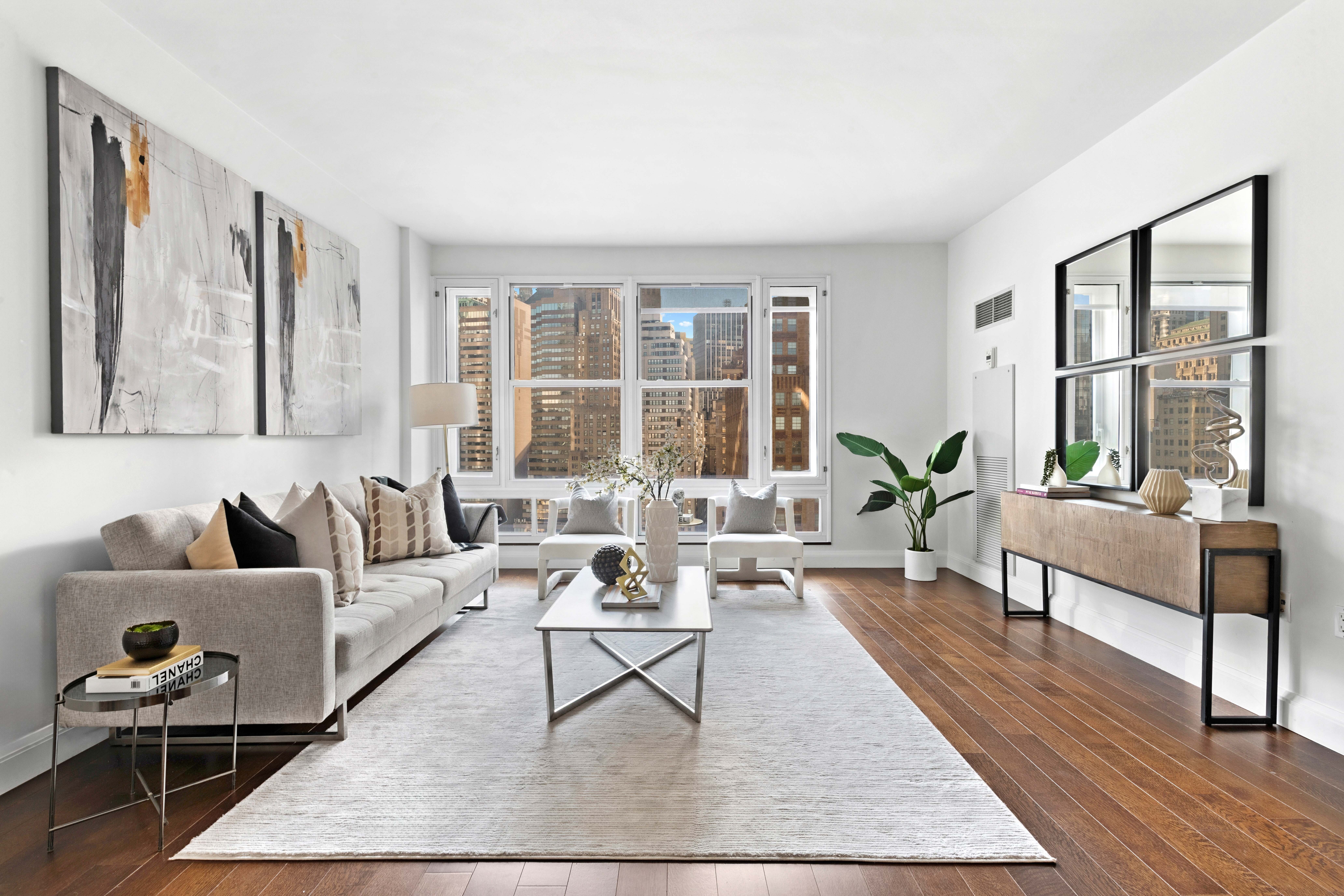 70 Little West Street, Unit 22G Manhattan, NY 10004 - Photo 2 of 13 a living room with furniture and a large window