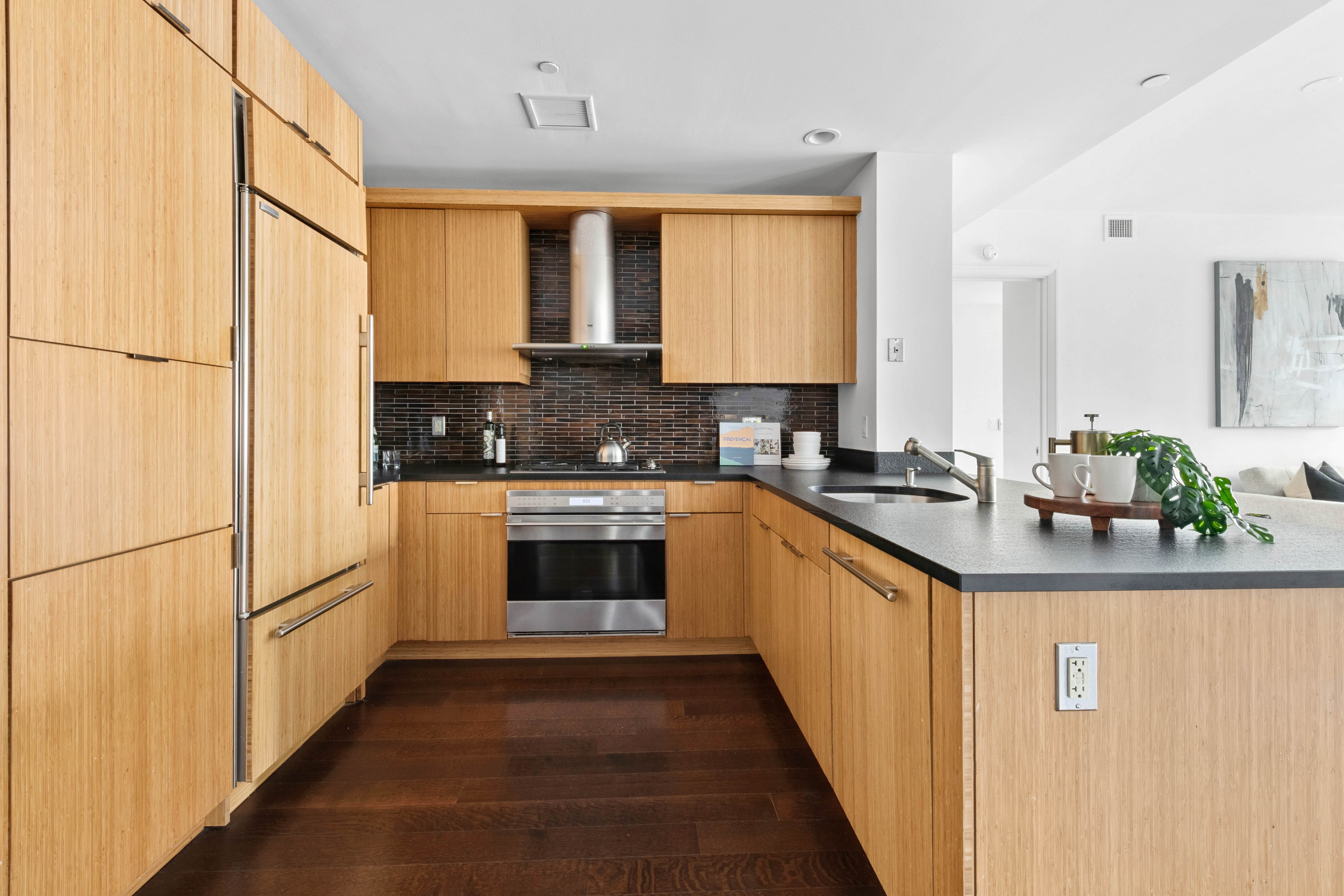 70 Little West Street, Unit 22G Manhattan, NY 10004 - Photo 4 of 13 a kitchen with white cabinets and white appliances