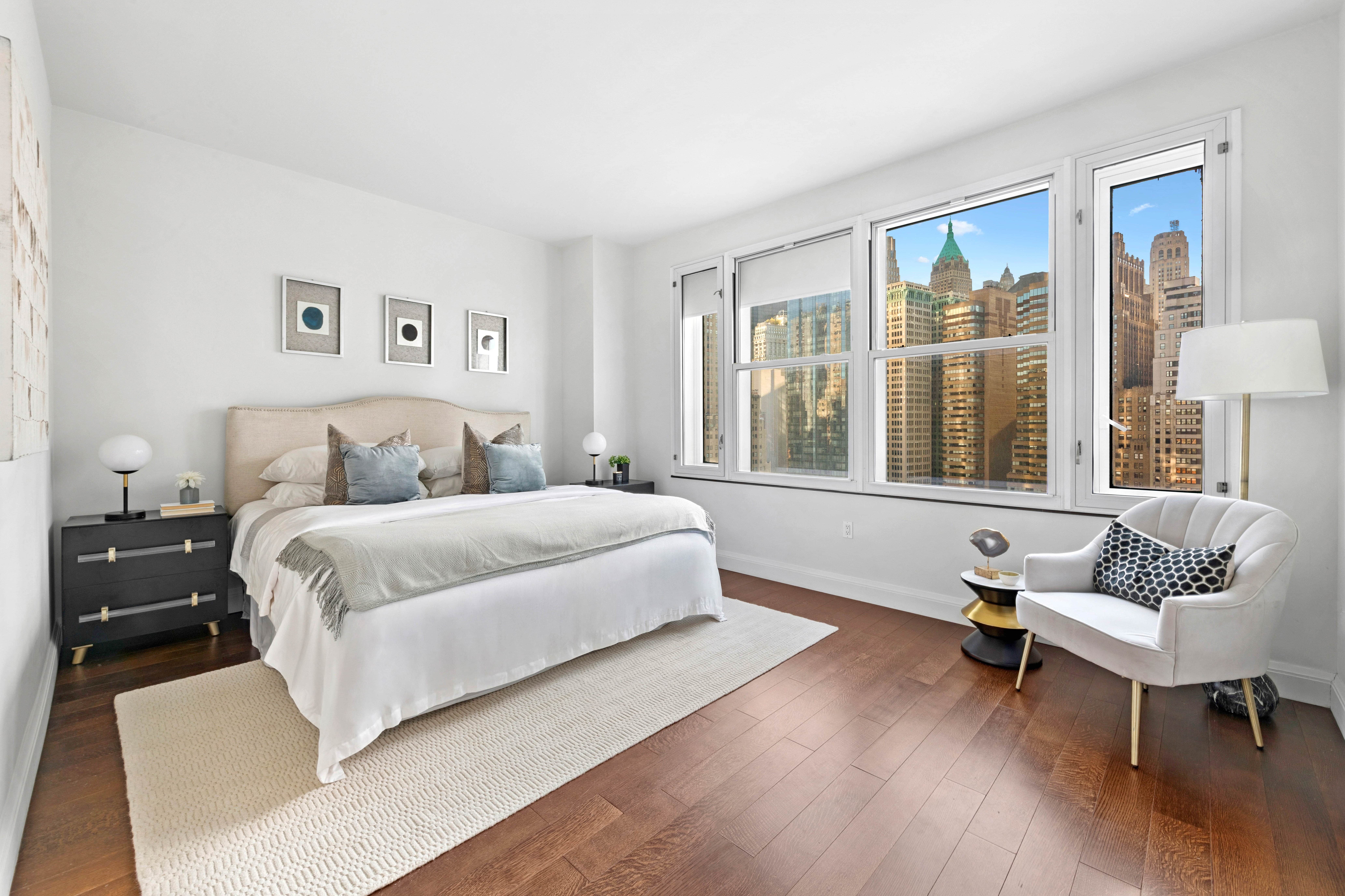 70 Little West Street, Unit 22G Manhattan, NY 10004 - Photo 5 of 13 a bedroom with a bed and wooden floor