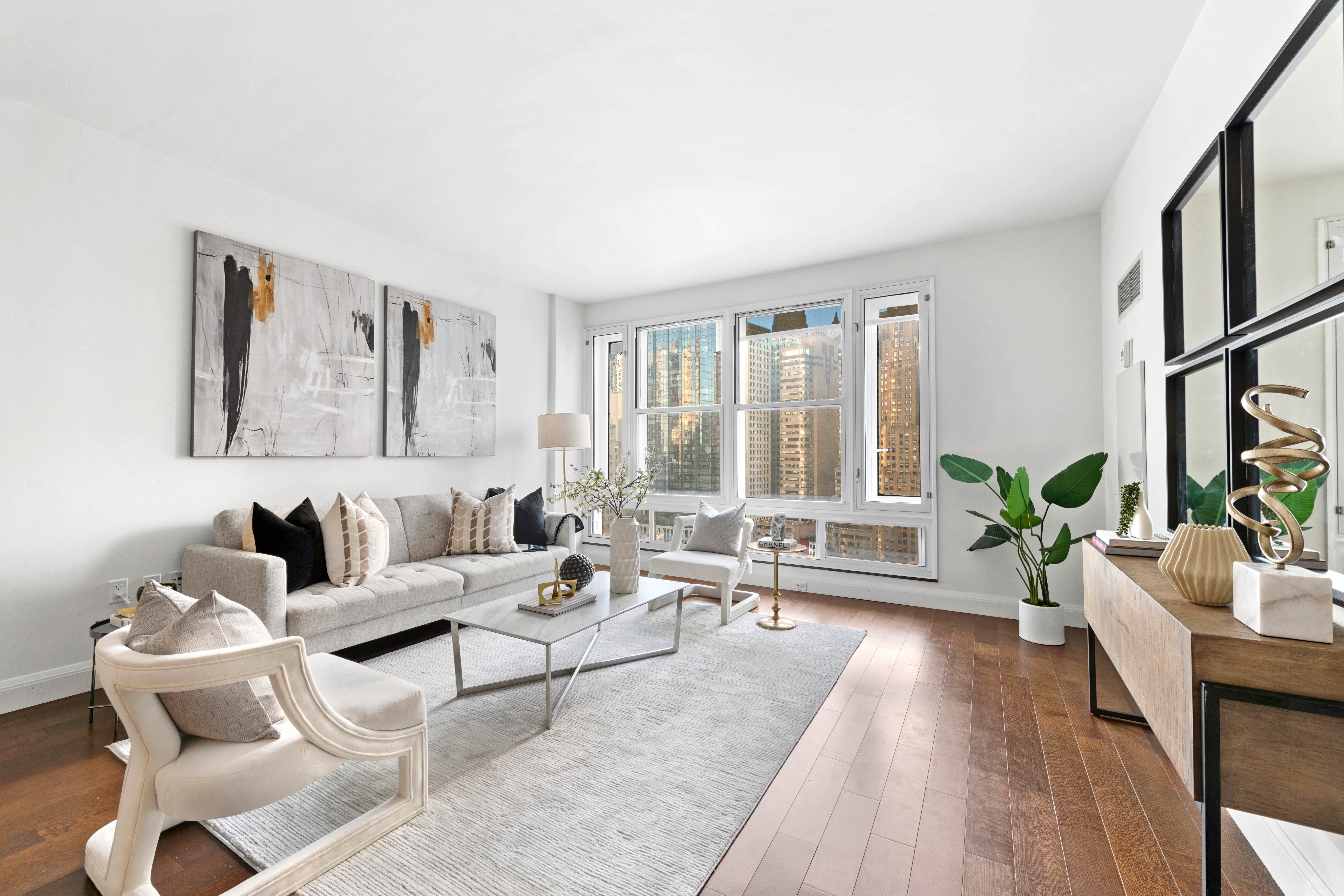 70 Little West Street, Unit 22G Manhattan, NY 10004 - Photo 6 of 13 a living room with furniture and a large window