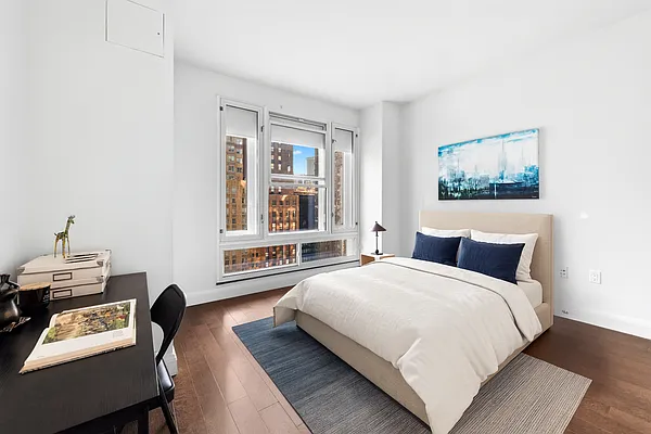 70 Little West Street, Unit 22G Manhattan, NY 10004 - Photo 9 of 13 a bedroom with a bed and wooden floor