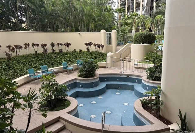 a dining hall with stainless steel appliances a dining table and chairs with kitchen view