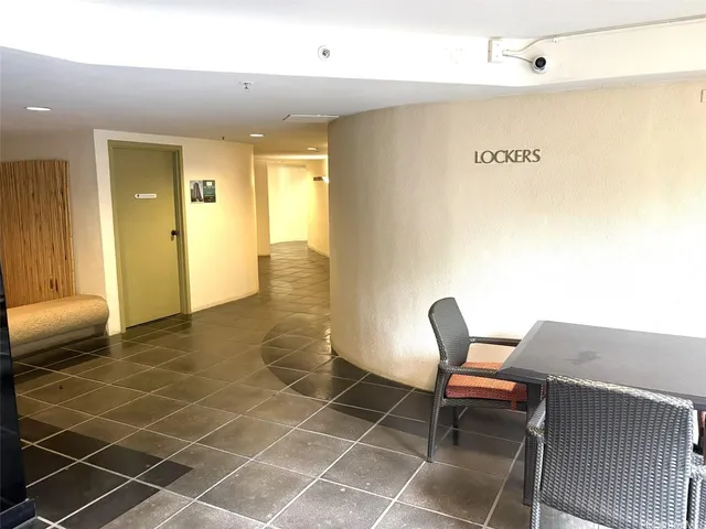 a view of a patio with table and chairs under an umbrella
