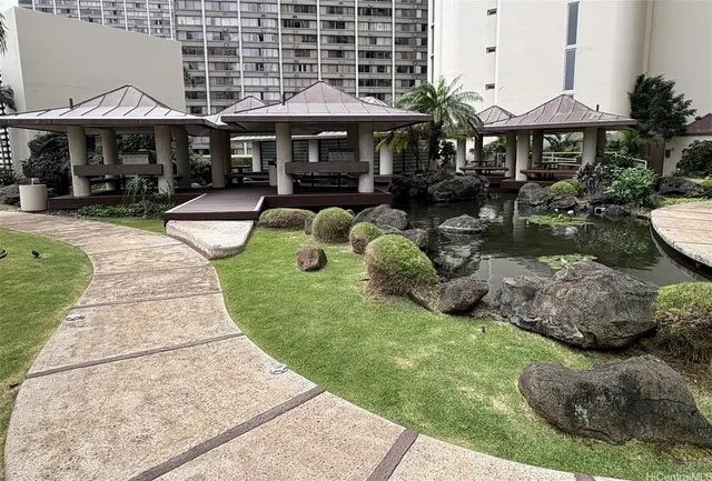 a balcony with dining table and chairs