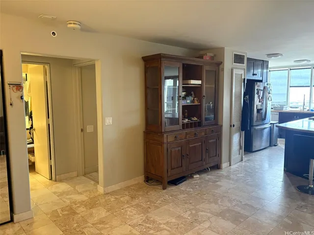a view of kitchen with refrigerator and window