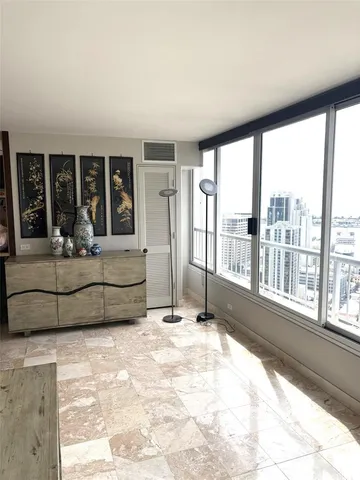 a living room with furniture and large windows