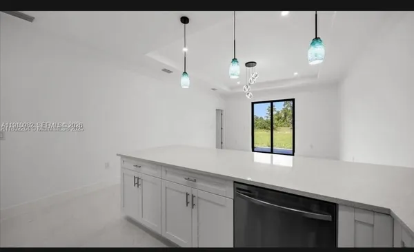 a kitchen with a sink cabinets and window