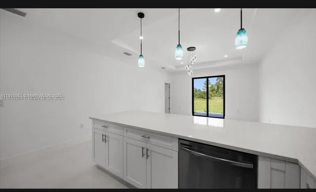 a kitchen with a sink cabinets and window