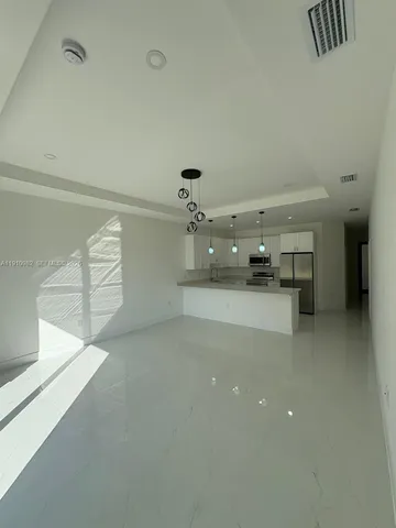 a view of a livingroom with furniture and natural light