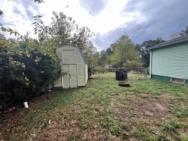 a backyard of a house with a stove and barbeque oven