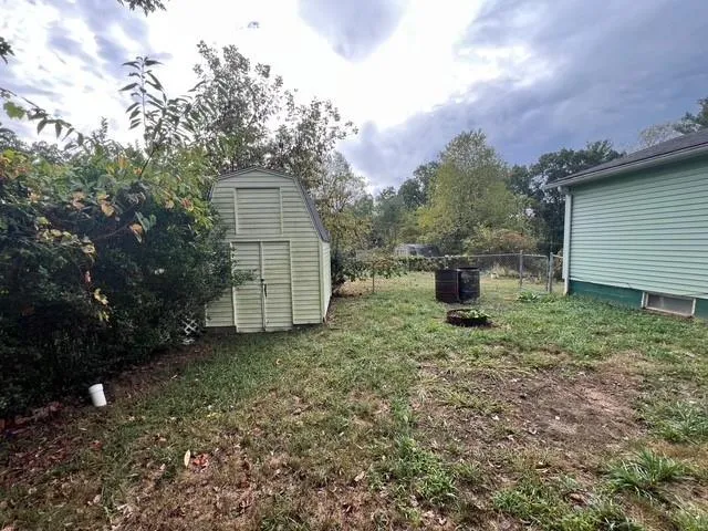 a backyard of a house with a stove and barbeque oven