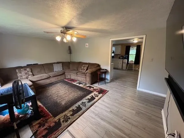 a living room with furniture and wooden floor